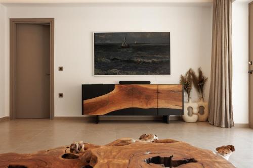 a bedroom with a bed and a painting on the wall at GkF Luxury Villas in Naxos Chora