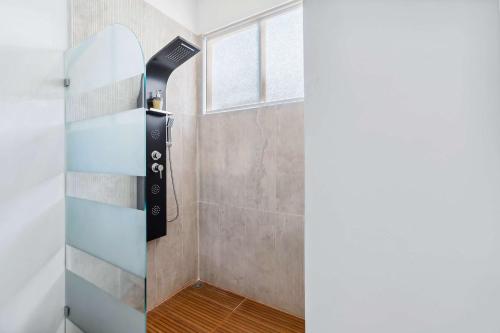 a shower with a glass door in a bathroom at Modern 4BR Villa with Pool in Playa Grande