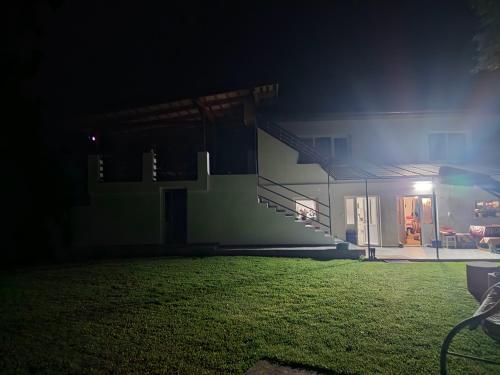 a house at night with a grassy yard in front at Garden Spa Retezat in Fizeşti