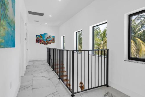 a hallway with white walls and a black iron gate at Horizon in Marathon