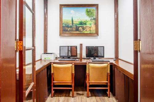 a room with a desk with two chairs and a computer at Best Western Majestic in Mexico City