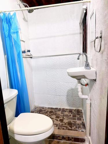 a bathroom with a toilet and a sink at Alo México in Mexico City