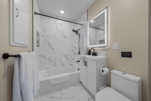 a white bathroom with a shower and a toilet at No bad days in San Diego in San Diego