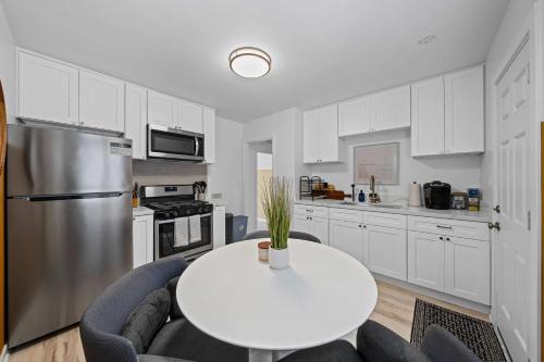 a white kitchen with a white table and chairs at No bad days in San Diego in San Diego