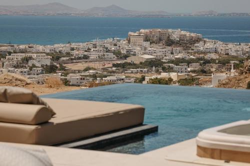 a pool with a view of a city and the ocean at GkF Luxury Villas in Naxos Chora