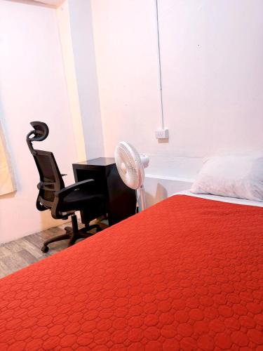 a bedroom with a bed and a desk and a fan at Alo México in Mexico City