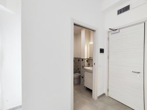 a bathroom with a white door and a toilet at Residence Mario Bianco in Milan