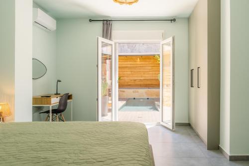 a bedroom with a bed and a desk and a window at Sofia Villa in Krousón