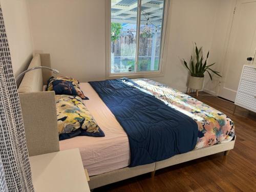a large bed in a room with a window at Modern Home with Full Gym & Personal garden in San Jose