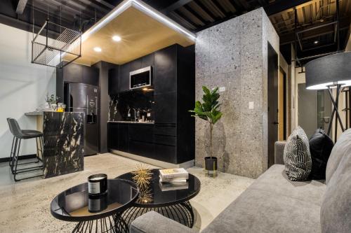 a living room with a couch and a table at Downtown Designer Apartments by ULIV in Tijuana