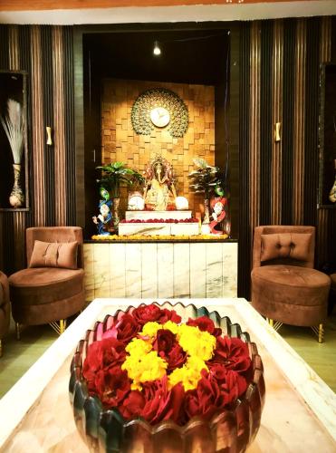 a large flower arrangement on a table in a lobby at Shri Shyam Luxury Hotel in Har Ki Paudi in Haridwār
