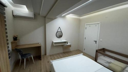 a bedroom with a bed and a mirror and a chair at The Urban Nest Central Skopje Cozy 2BR Ap in Skopje