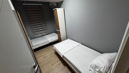 a small room with a bed and a mirror at The Urban Nest Central Skopje Cozy 2BR Ap in Skopje