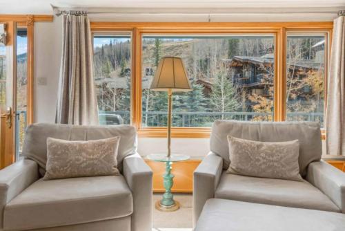 a living room with two chairs and a large window at Lodge Tower 387 Three Bedroom Residence in Vail