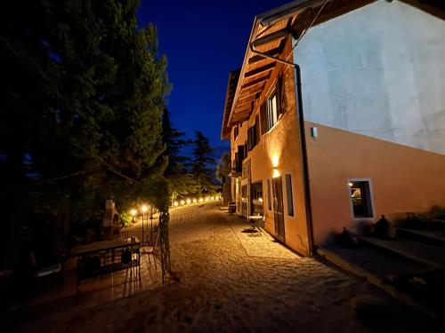 an empty street with a building at night at Relais Portaluna delle Langhe in Mango