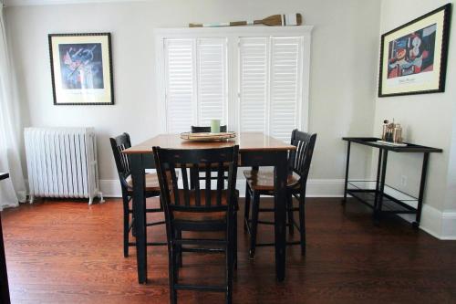 a dining room with a wooden table and chairs at Charming Home On The Point in Newport