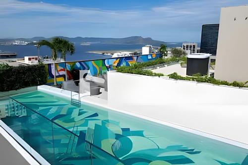 a swimming pool on the roof of a building at Skylux Studios de Luxo in Rio de Janeiro