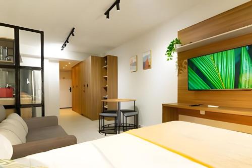 a bedroom with a bed and a flat screen tv at Skylux Studios de Luxo in Rio de Janeiro