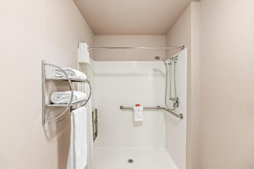 a white bathroom with a shower and a sink at Ledgestone Suites Hotel Vernal in Vernal
