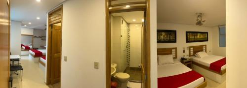 a room with a bedroom with a bed and a mirror at Hotel Portal Central in Medellín