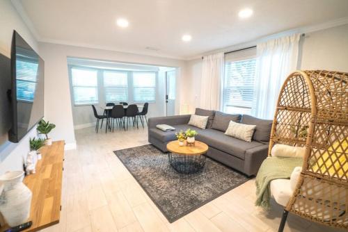 a living room with a couch and a table at Tranquil & Fully Renoveted Home Near Busch Gardens in Tampa