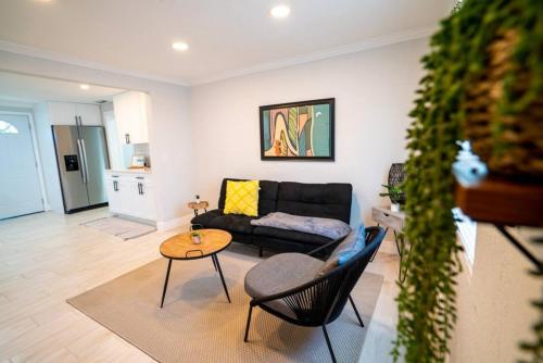a living room with a couch and a table at Tranquil & Fully Renoveted Home Near Busch Gardens in Tampa