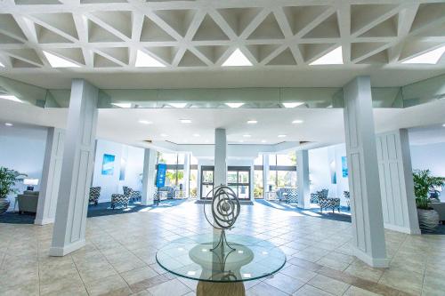 a lobby with a table in the middle of a building at Upgraded and Spacious Harbor Towers Condo! Siesta Key Vacation! in Siesta Key
