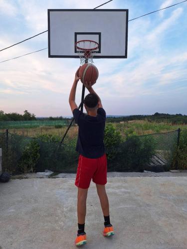 a man is playing with a basketball hoop at Brvnara Luni in Kruševac