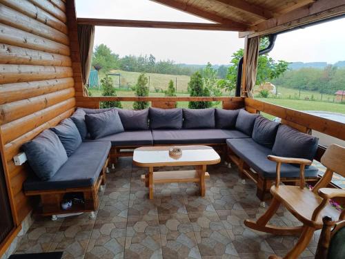 a living room with a blue couch and a table at Brvnara Luni in Kruševac