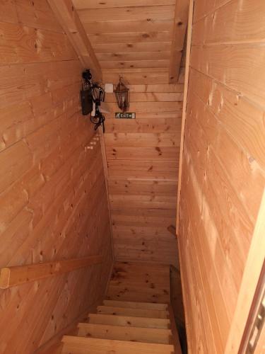 an inside view of a wooden room with stairs at Brvnara Luni in Kruševac
