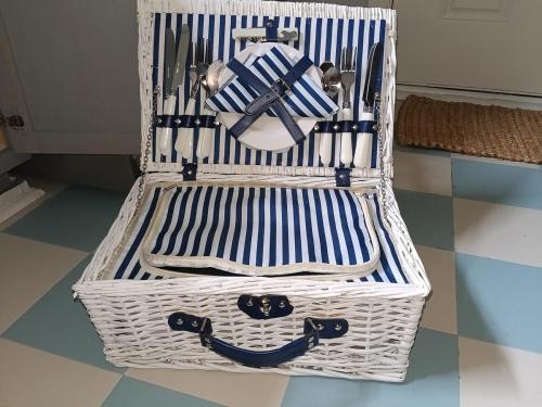 a white basket sitting on a tile floor at Pensacola hidden gem cottage 3 minutes from Navy Base, pet friendly in Pensacola
