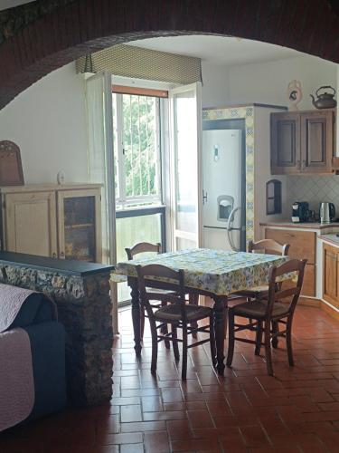 a living room with a table and chairs and a kitchen at Casa Cleopatra in Il Romito