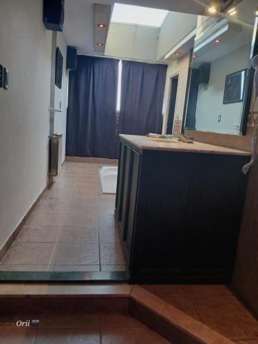 a bathroom with a sink and a mirror at Hotel Paradayca 9 de Julio 