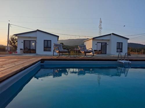 a house with a swimming pool in front of a house at Etno Lux Isaković in Ulcinj