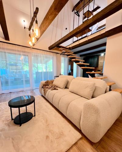 a living room with a large couch and a table at Silent Lake in Látrány