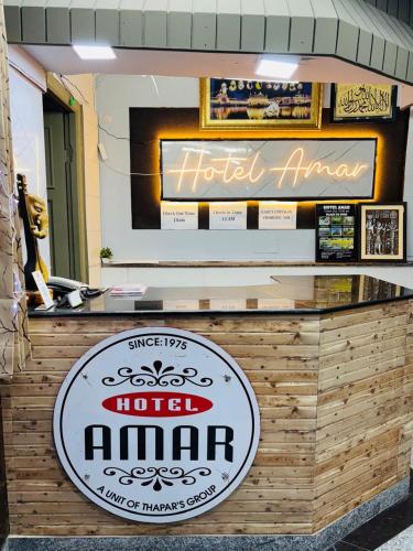 a hotel entrance with a sign for a hotel istg at Hotel Amar in Mussoorie