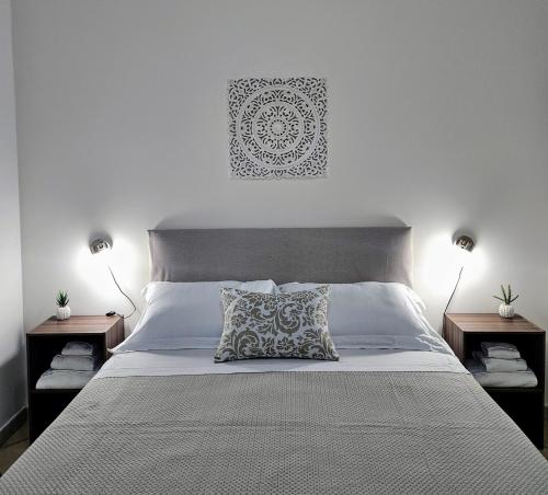 a bedroom with a large bed with two night stands at Dimora Sole del Sud in Ugento