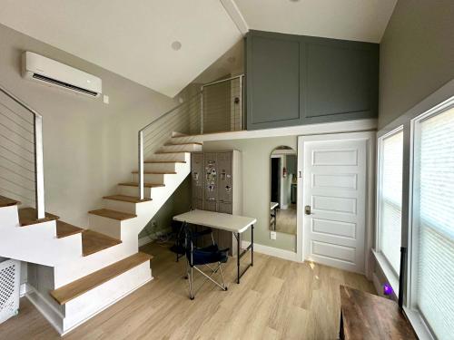 a room with a staircase and a table and a door at Tiny Private Room #2 in Shared 5BR House with Other Guests in Austin