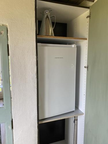a cabinet in a kitchen with a white door at Lykkeholms Bella Vista in Spottrup