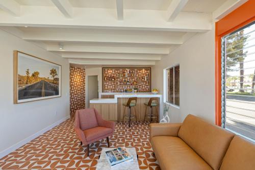 a living room with a couch and a bar at Mojave Resort - Adults Only in Palm Desert