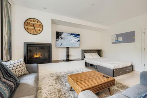 a living room with a couch a bed and a fireplace at River West 822 in Silverthorne
