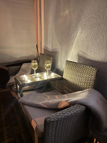 a table and two glasses of wine on a balcony at Harmony Suite Apartment in Pápa