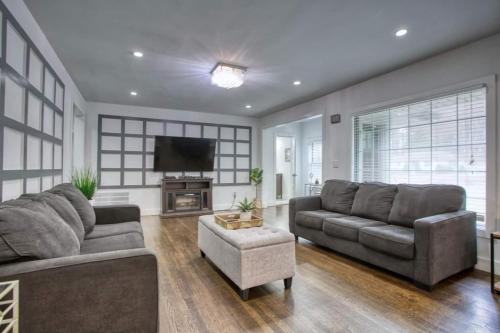a living room with two couches and a television at Buckhead 8BR GetawayOpen Layout,Ideal for Groups in Atlanta