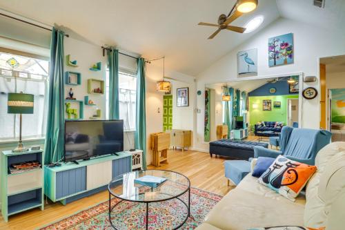 a living room with a couch and a tv at Outdoor Bar and Large Pool Retro ABQ Retreat! in Albuquerque