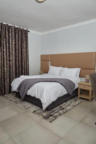 Кровать или кровати в номере Mountain Drive Apartments