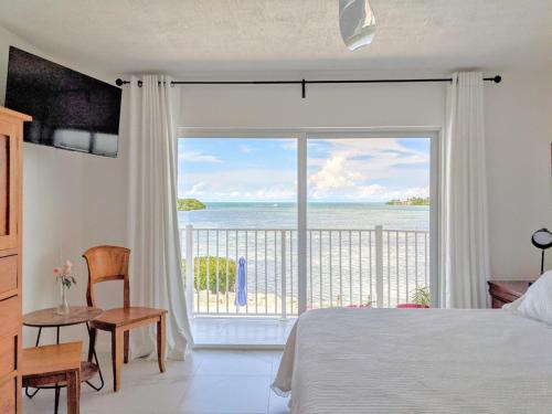 a bedroom with a bed and a view of the ocean at Ocean Dream in Marathon