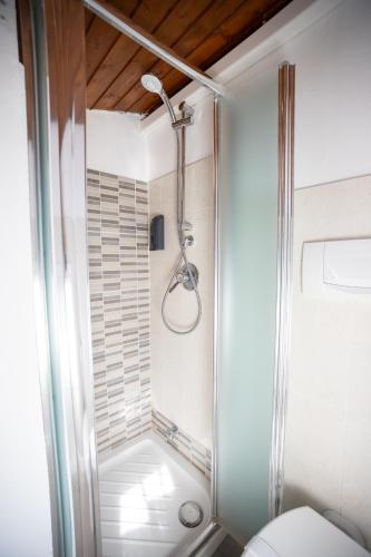 a shower in a bathroom with a toilet at Duplex San Fedele in Como