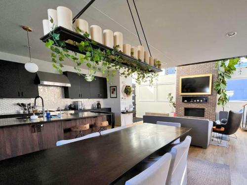 a kitchen with a large wooden table in a room at Modern Luxury Home I Sleeps 8 I 10min to Downtown in Denver