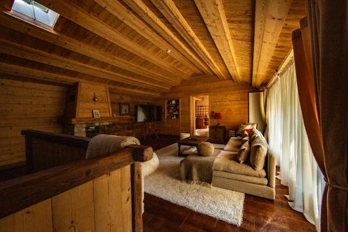 a living room in a log cabin with a couch at Beauregard Jura - Countryside Estate Stays Near Geneva in Gex