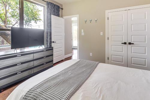a bedroom with a bed and a flat screen tv at Lake Travis House with Private Dock, Pool and Hot Tub! in Leander